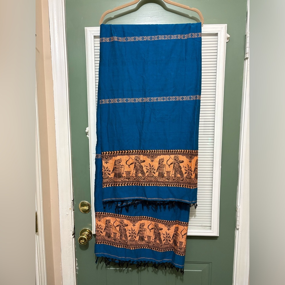 blue cotton saree with a printed border pallu featuring traditional Indian art.